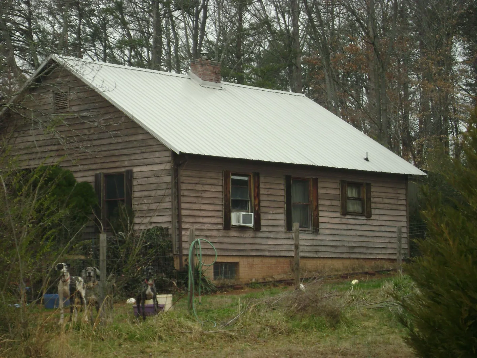 White metal roof on an old wood sided farmhouse, from a Metal Roof Installation job in Ebensburg